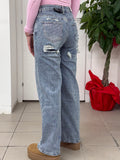 Jeans a palazzo con taschino e strappo brillantinato